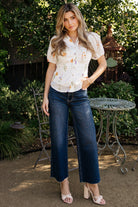 Three-quarter side view of dark wash Kirby high-rise wide-leg jeans on model, highlighting the wide leg drape and natural stretch of the denim fabric.