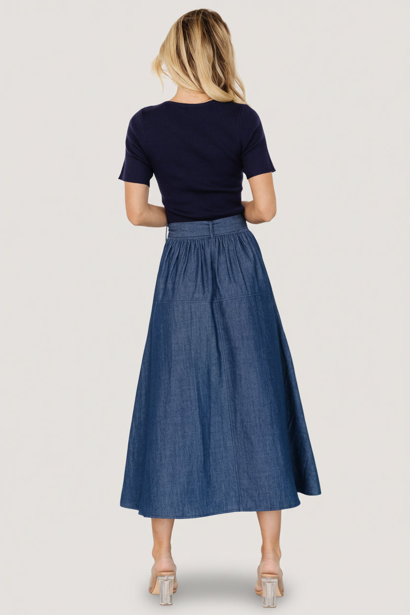 Model walking in the Olina midi dress, showing natural movement of the skirt and the short sleeve silhouette.