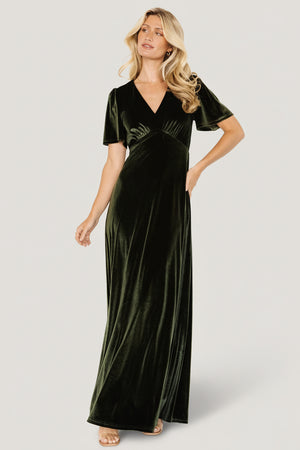 Model front view in olive Vivian Velvet Maxi Dress on a clean studio background, showing deep V-neck, gathered bust, and full flowing skirt.