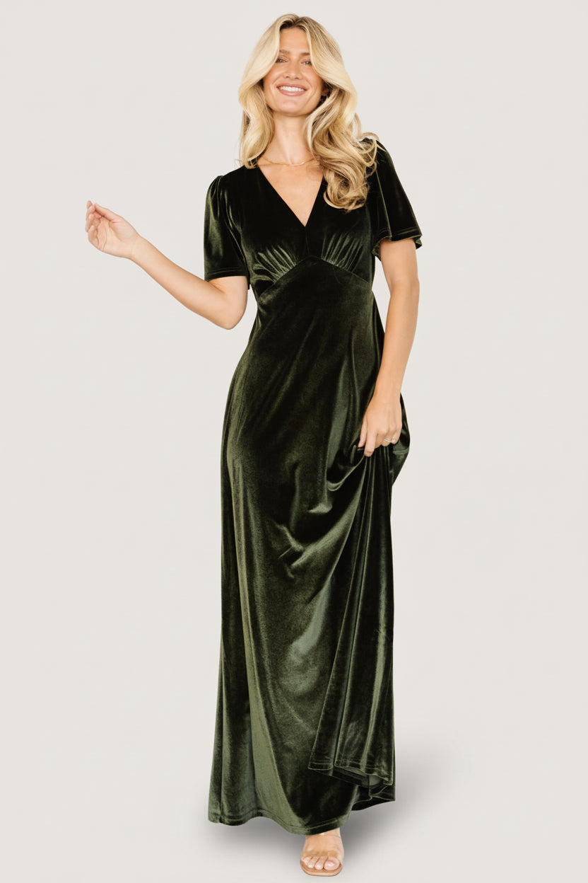 Back view of the olive velvet dress on a plain background, showing keyhole closure and the graceful fall of the gown-length skirt.