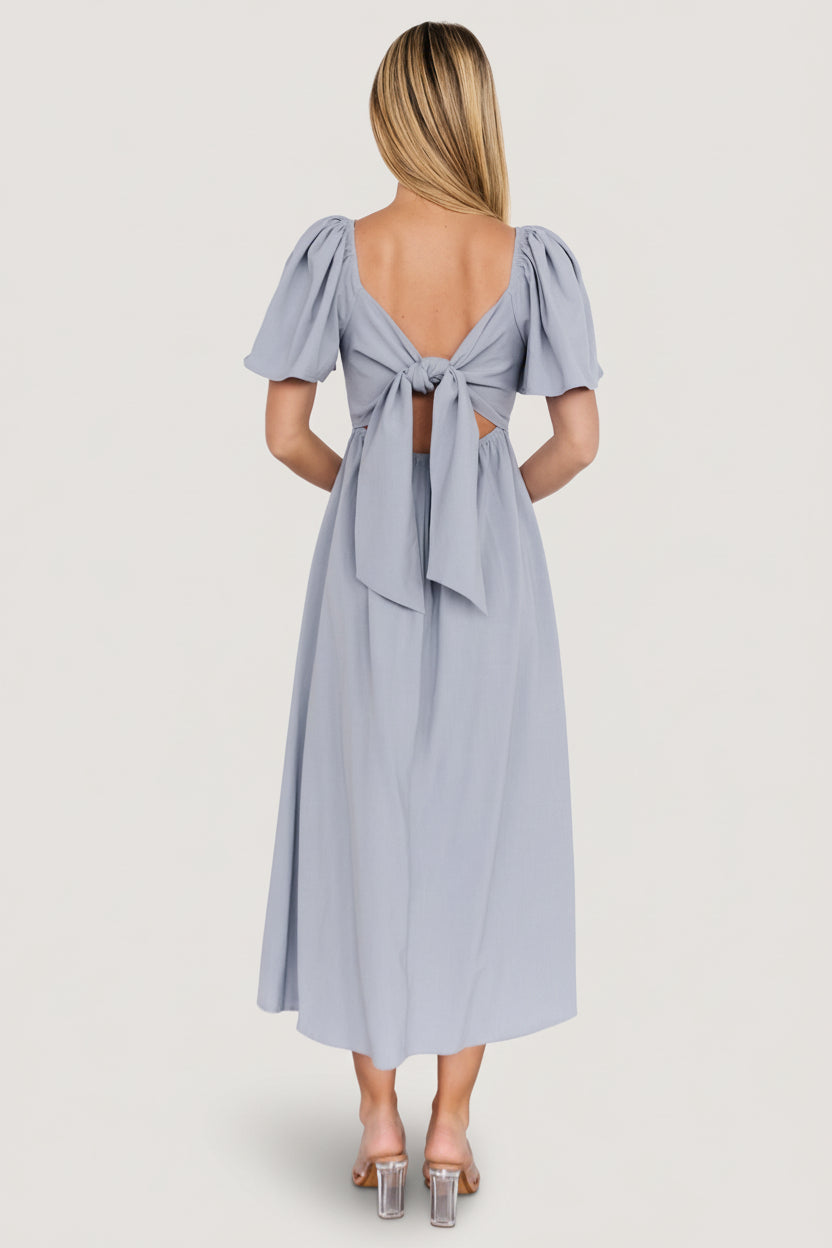 Back detail close-up of Indie Back Tie Dress showing adjustable tie closure and unlined bodice in dusty blue fabric.