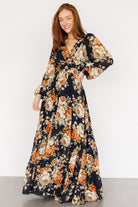 Three-quarter view showing the Johanna dress's long airy sleeves with elastic cuffs and the back keyhole button detail.