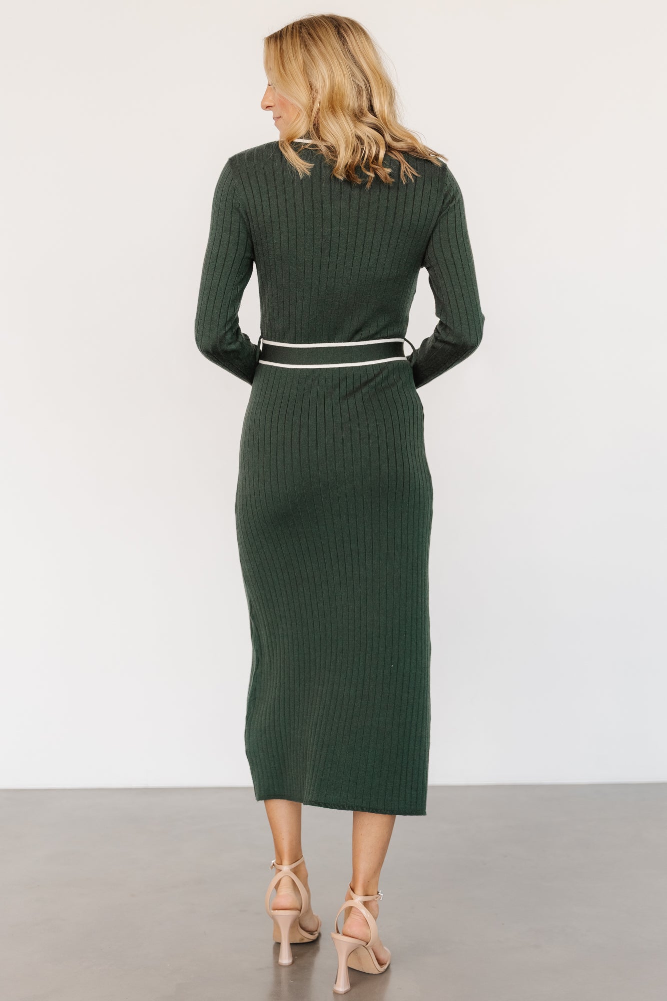 Close-up detail of the Lark dress collar and upper bodice, showing ribbed knit texture, rugby-style V-neck, and subtle ivory contrast stitching.