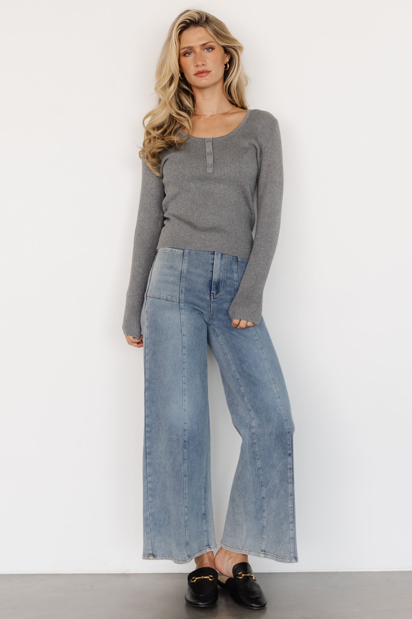 Side view of model wearing the Leo Ribbed Henley Top in gray, showing sleeve length, slim fit, and ribbed hem.