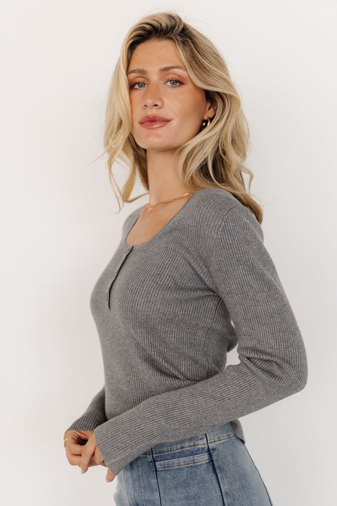 Flat lay of Leo Ribbed Henley Top in heathered gray, folded to display scoop neckline, button placket, and ribbed pattern.