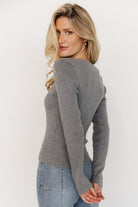 Styled look: Leo Ribbed Henley Top paired with mid-rise wide-leg jeans, illustrating a casual, everyday outfit pairing idea.