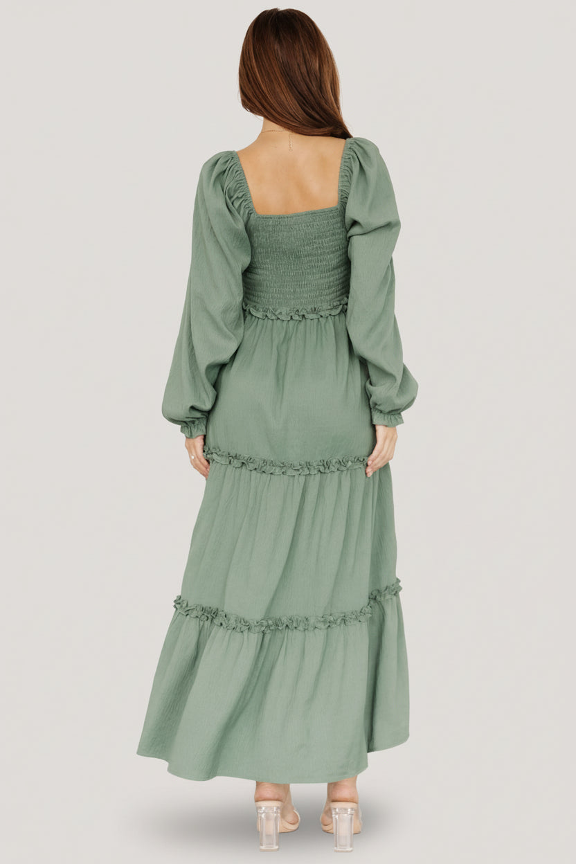 Close-up of smocked bodice and sweetheart neckline on the dark sage Britta Maxi Dress highlighting faux bow cinch detail.