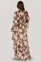 Detail of cascading tiered ruffles on the maxi skirt showing movement, layered construction and the mocha floral print.