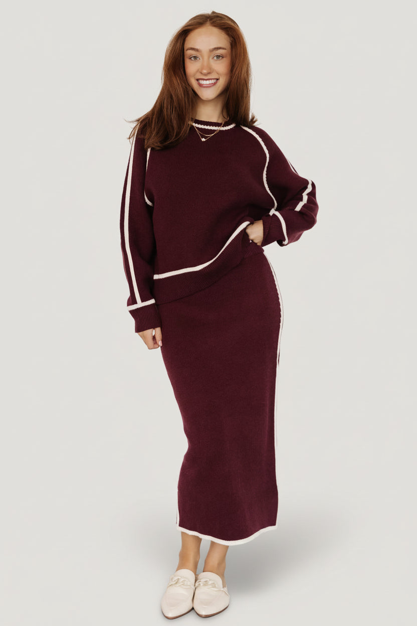 Three-quarter view of Ava knit sweater in wine, displaying relaxed silhouette, round neckline, and soft drape over the torso.