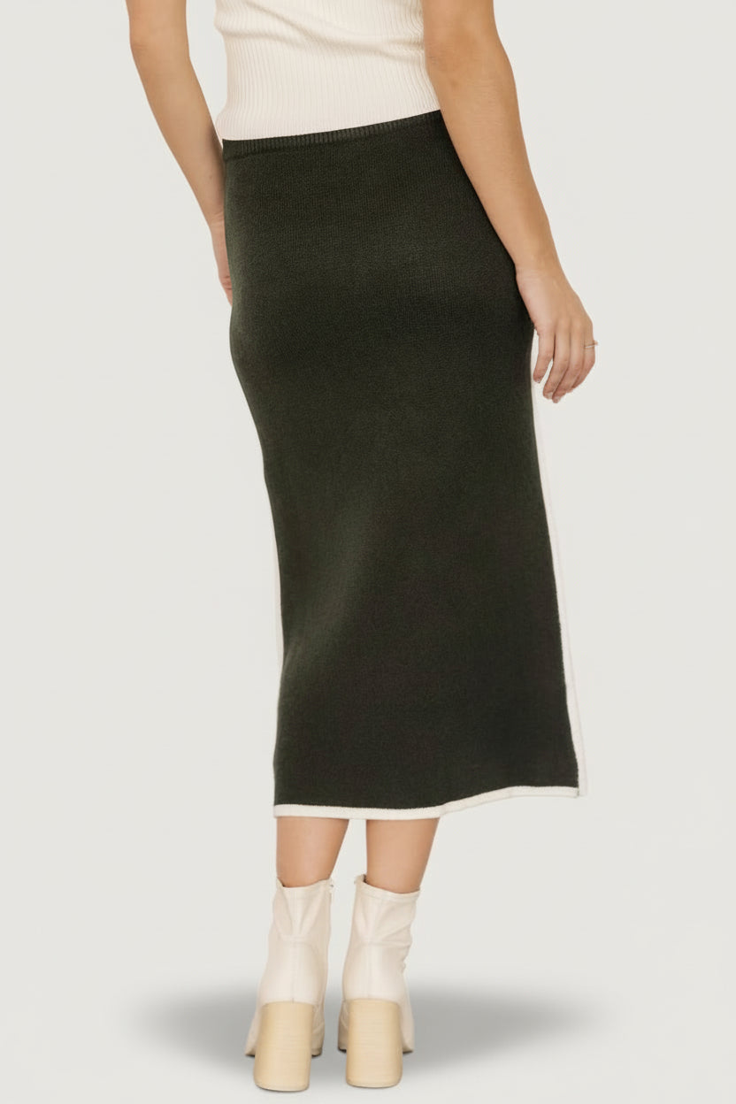 Back view of Ava Knit Midi Skirt in dark green on model, showing fit through the hips and the skirt’s midi-length silhouette.