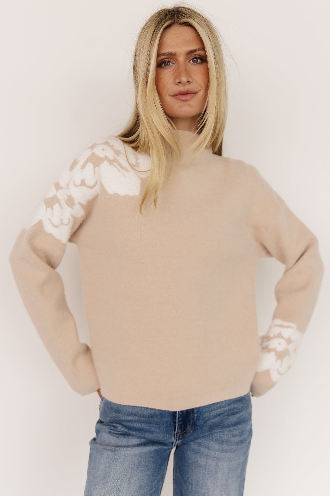 Front view of Oda Floral Sweater in natural with raised fuzzy ivory flower texture and boxy mock neckline, styled on model.