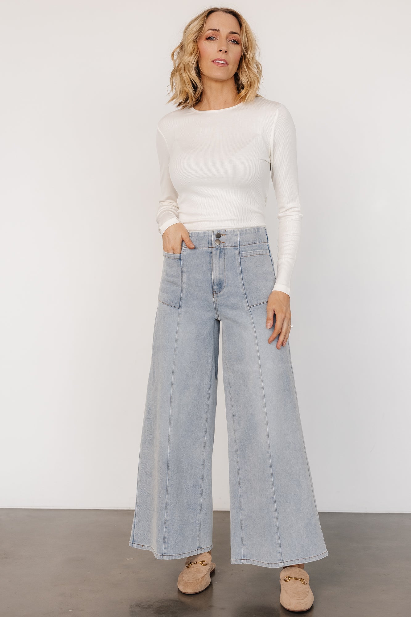 Close-up detail of Emmi jeans mustard contrast stitching and fabric texture showing the stretch denim weave and stitched seam accents.