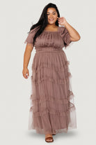 Three-quarter model pose in dusty mink Magdalena Tulle Maxi Dress highlighting elastic ruffled waist and flowing tiered tulle skirt.