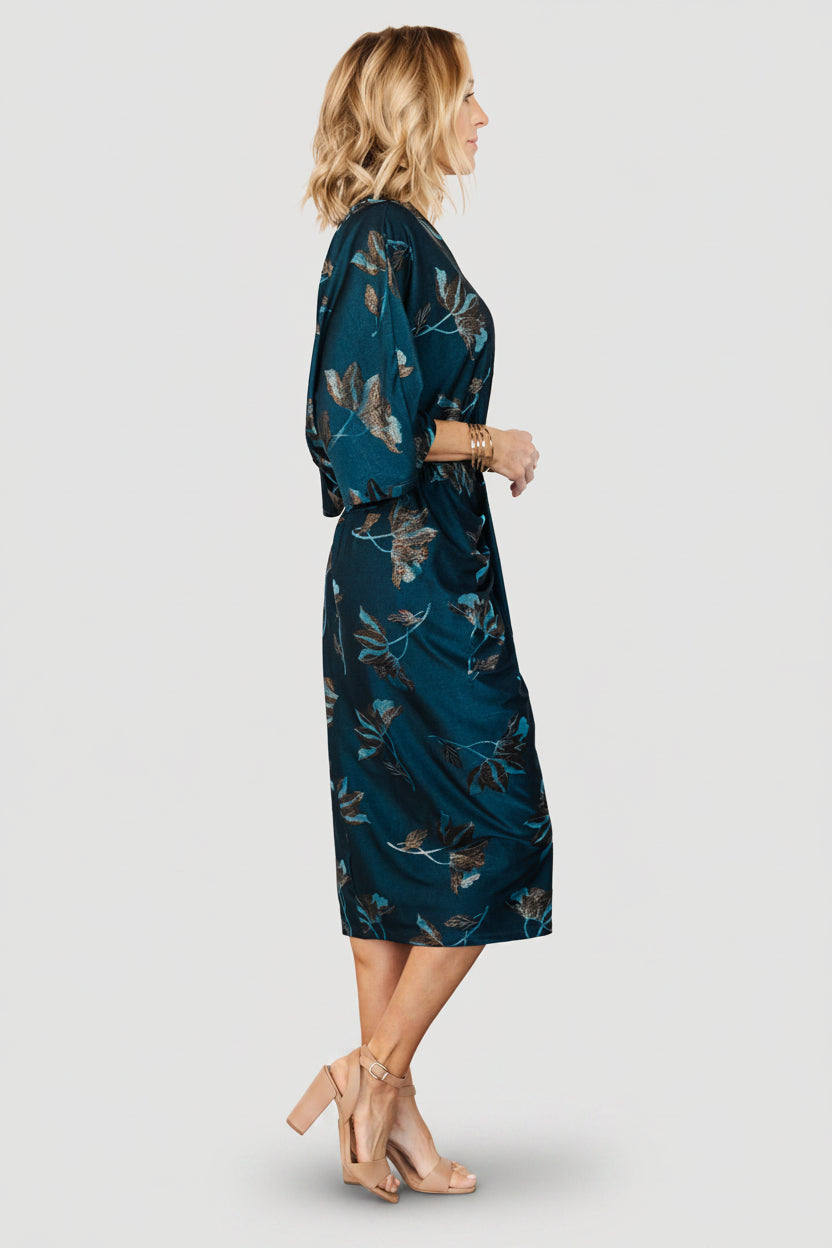 Full-length shot of the Shaneen ruched midi dress in jade floral shimmer, showing silhouette, midi hem and travel-friendly knit.
