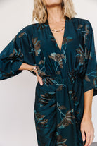 Close-up of the Shaneen dress fabric showing jade and black floral print with delicate shimmer and soft stretch-knit texture.