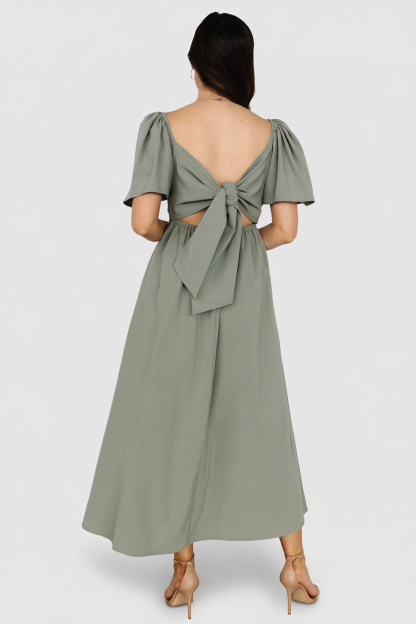 Styled outfit photo of dusty green midi paired with neutral accessories, showing versatility for daytime and evening wear.