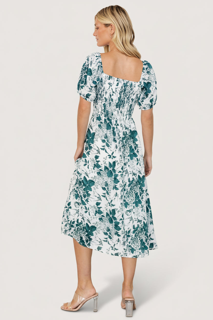 Full-length image of model wearing the Cadence Midi Dress in jade floral, showing overall fit, sleeve shape, and mid-calf hemline.