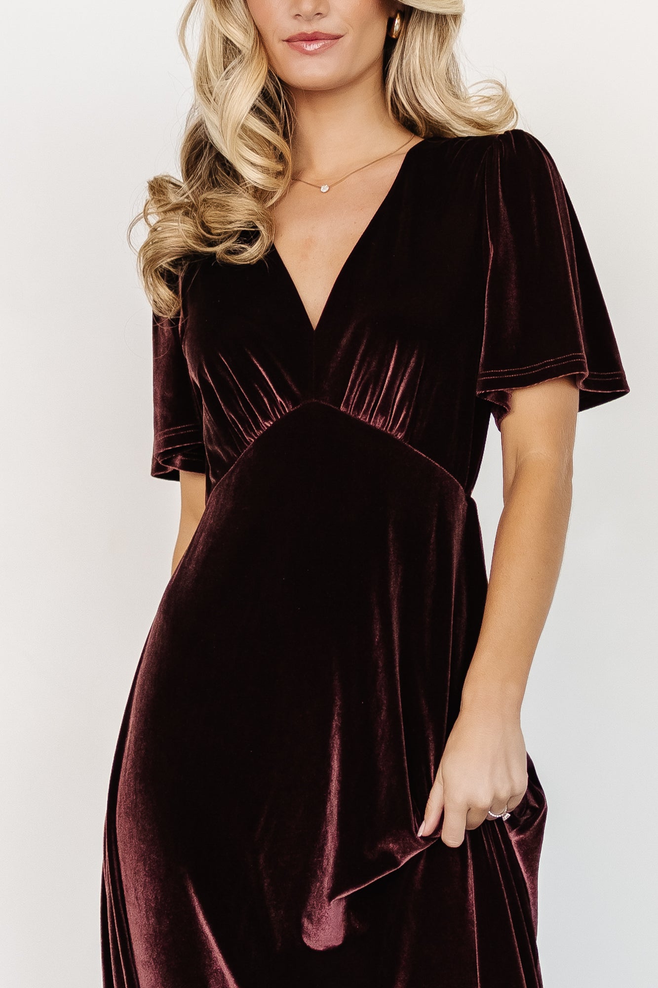 Close-up of the dress bodice in Clove, displaying the gathered bust detail, deep V neckline, and the plush texture of the stretch velvet fabric.