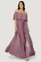 Back and profile view of the vintage plum maxi dress showing the lined mid-thigh underlayer, gathered waist, and graceful skirt movement.
