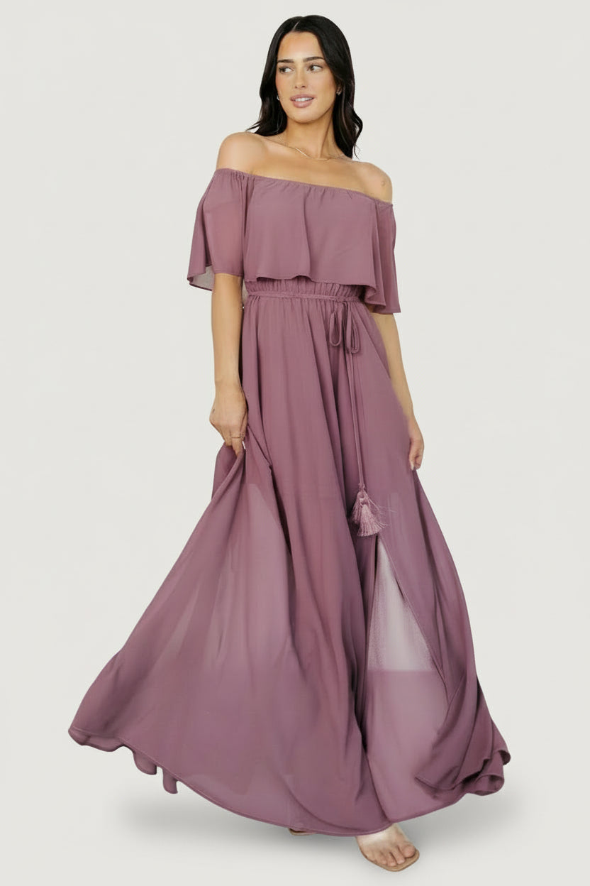 Back and profile view of the vintage plum maxi dress showing the lined mid-thigh underlayer, gathered waist, and graceful skirt movement.