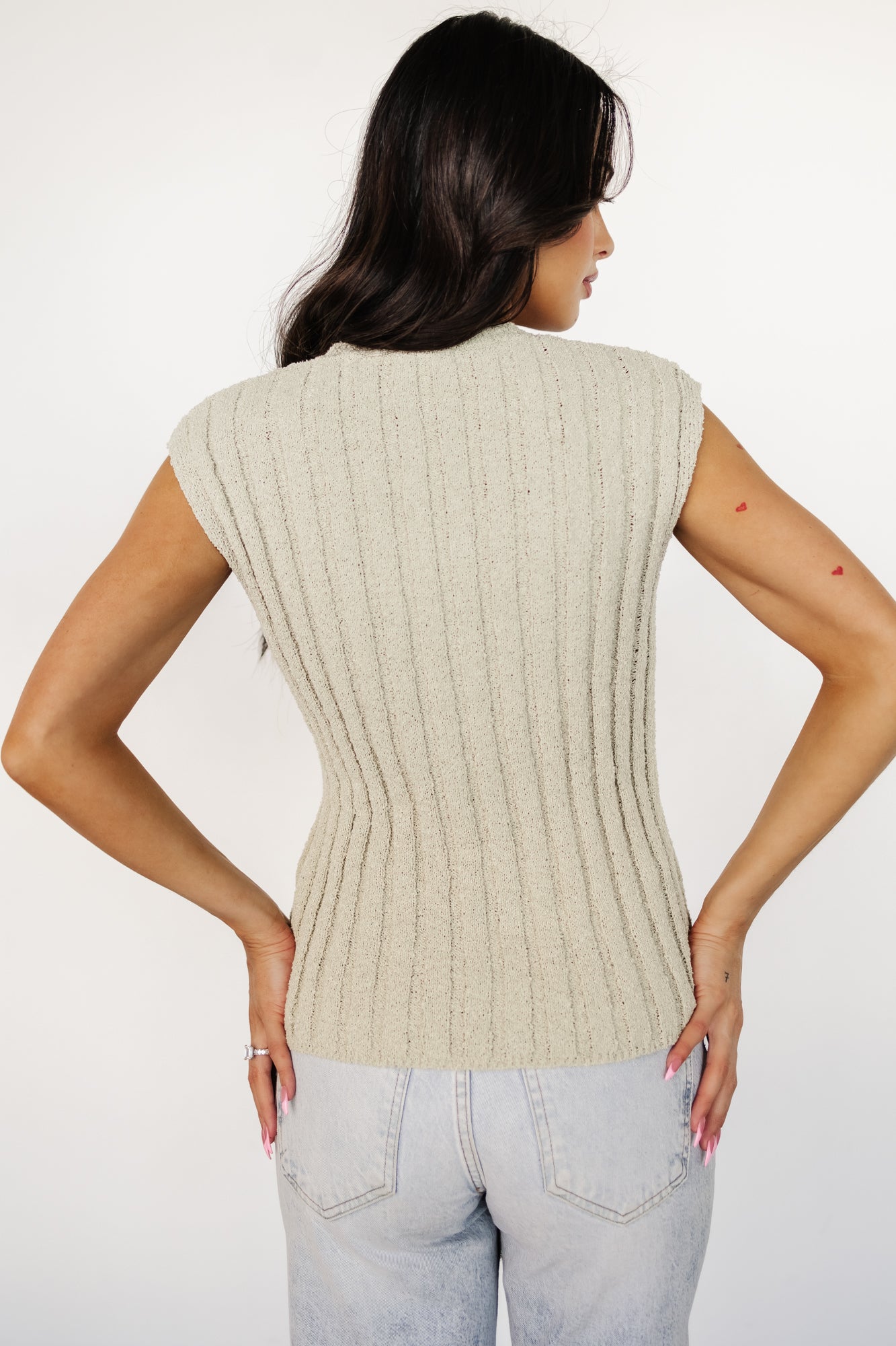Studio shot of the Dava ribbed short-sleeve top in dusty sage laid flat to highlight the round neckline, short sleeves, and overall shape.