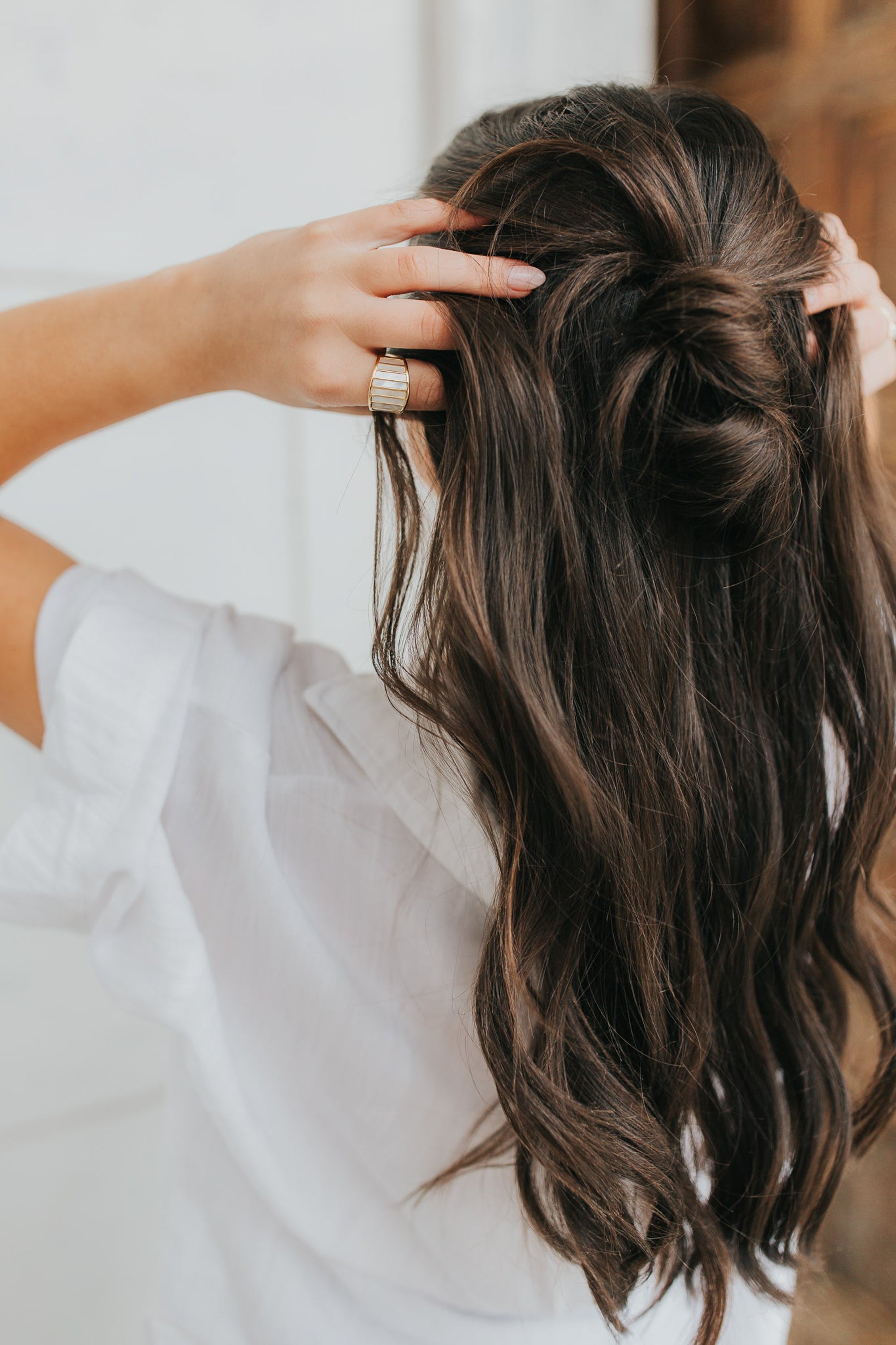 Macro view of the Alys ring inlay showing natural variations in the mother-of-pearl and the gold-plated band texture and finish.