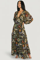 Styled shot of Bowman Deep V Maxi Dress in black multi floral paired with accessories, emphasizing its versatile occasion-ready look.