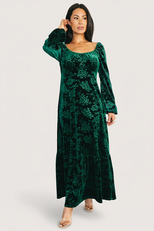 Front view of model in emerald Audra velvet embossed maxi dress showing scoop neckline, empire waist and midaxi skirt in soft burnout velvet fabric.