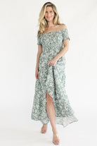Back view of the dusty sage tiered maxi dress showing the flowing skirt silhouette and comfortable off-shoulder fit.