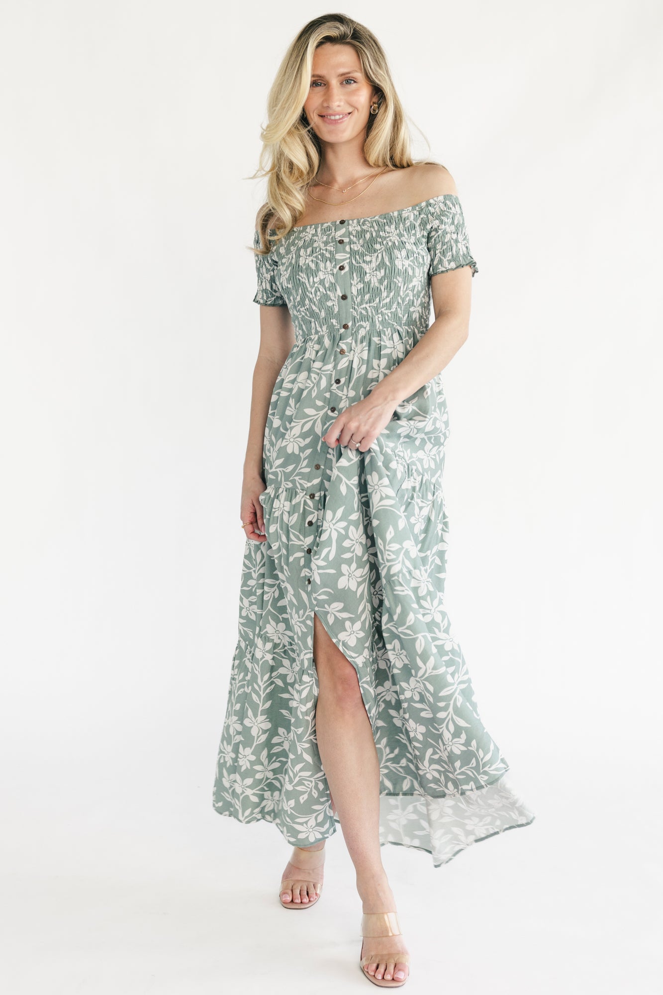 Back view of the dusty sage tiered maxi dress showing the flowing skirt silhouette and comfortable off-shoulder fit.