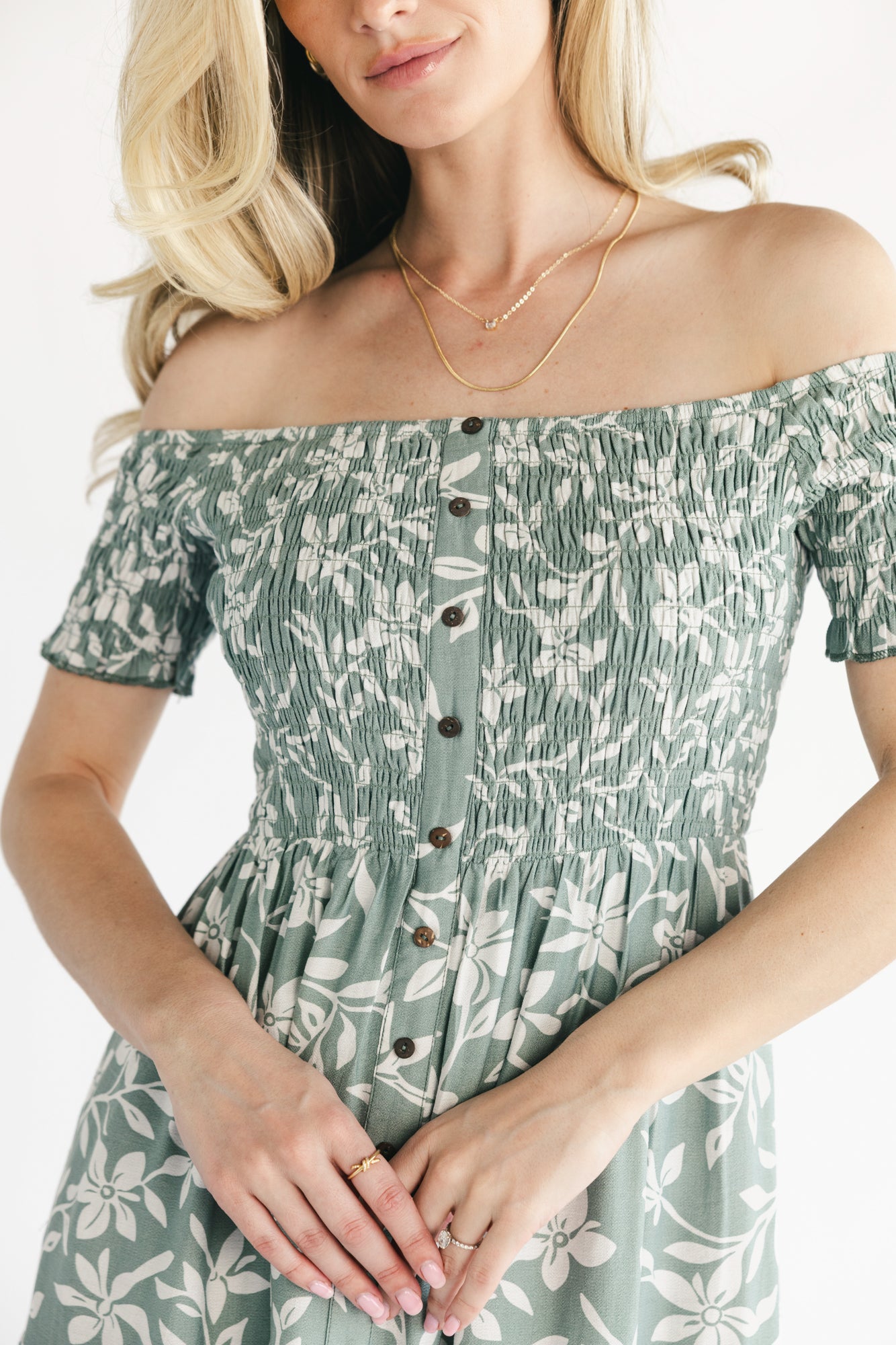 Three-quarter view of dusty sage Payton maxi dress highlighting short sleeves, off-shoulder elastic neckline, and tiered skirt movement.
