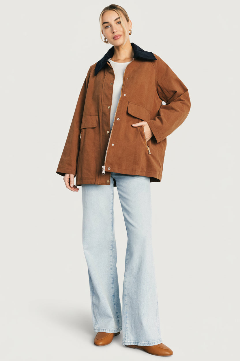 Close-up of the jacket's zip-front and snap placket with visible stitching and functional zip pockets for everyday use.