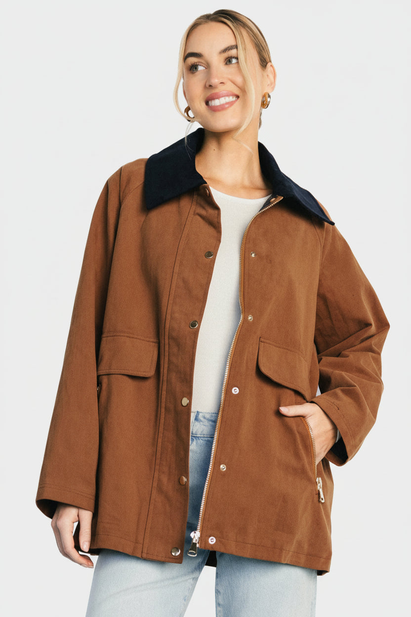 Front view of the Callahan Barn Jacket in cognac on model, showing corduroy collar, zip-and-snap front, and plaid lining at hem.
