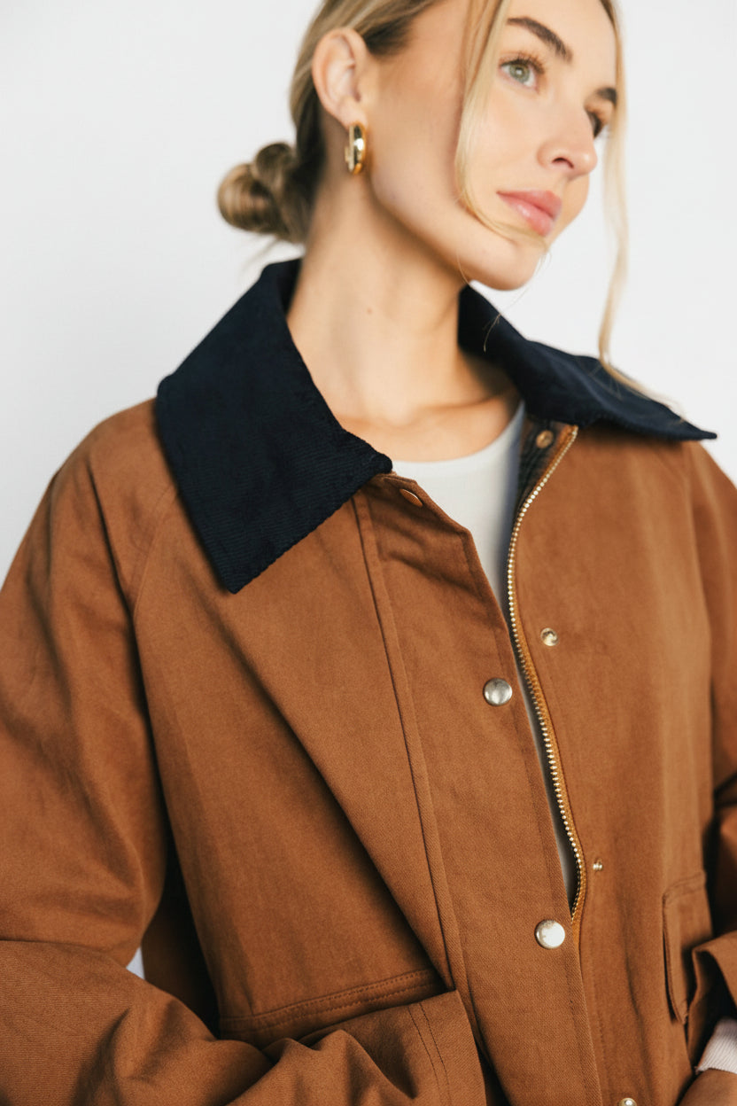 Back view of the Callahan Barn Jacket in cognac showing the decorative double-button back closure and boxy barn silhouette.