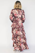 Clove satin maxi dress with a mauve floral print, V-neckline, short sleeves, a smocked back, and a flowing tiered ruffle skirt.