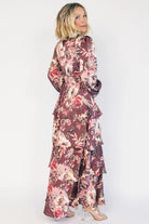 Clove satin maxi dress with a mauve floral print, V-neckline, short sleeves, a smocked back, and a flowing tiered ruffle skirt.