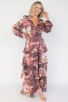 Clove satin maxi dress with a mauve floral print, V-neckline, short sleeves, a smocked back, and a flowing tiered ruffle skirt.