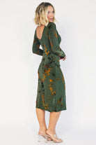 Green velvet floral midi dress with a boat neckline, long sleeves, side ruching, and a side slit.