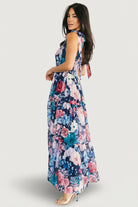 Close-up of Anita Maxi Dress fabric and print: dark blue base with pink and blue floral motifs and delicate chiffon texture.