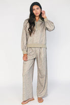Model wearing the Diana Lounge Set in Olive Floral featuring a matching long-sleeve half-zip top and wide-leg pants.