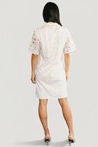 Close-up of Calida Lace Dress lace fabric and folded collar detail, showing delicate openwork and stitched lining at bodice.