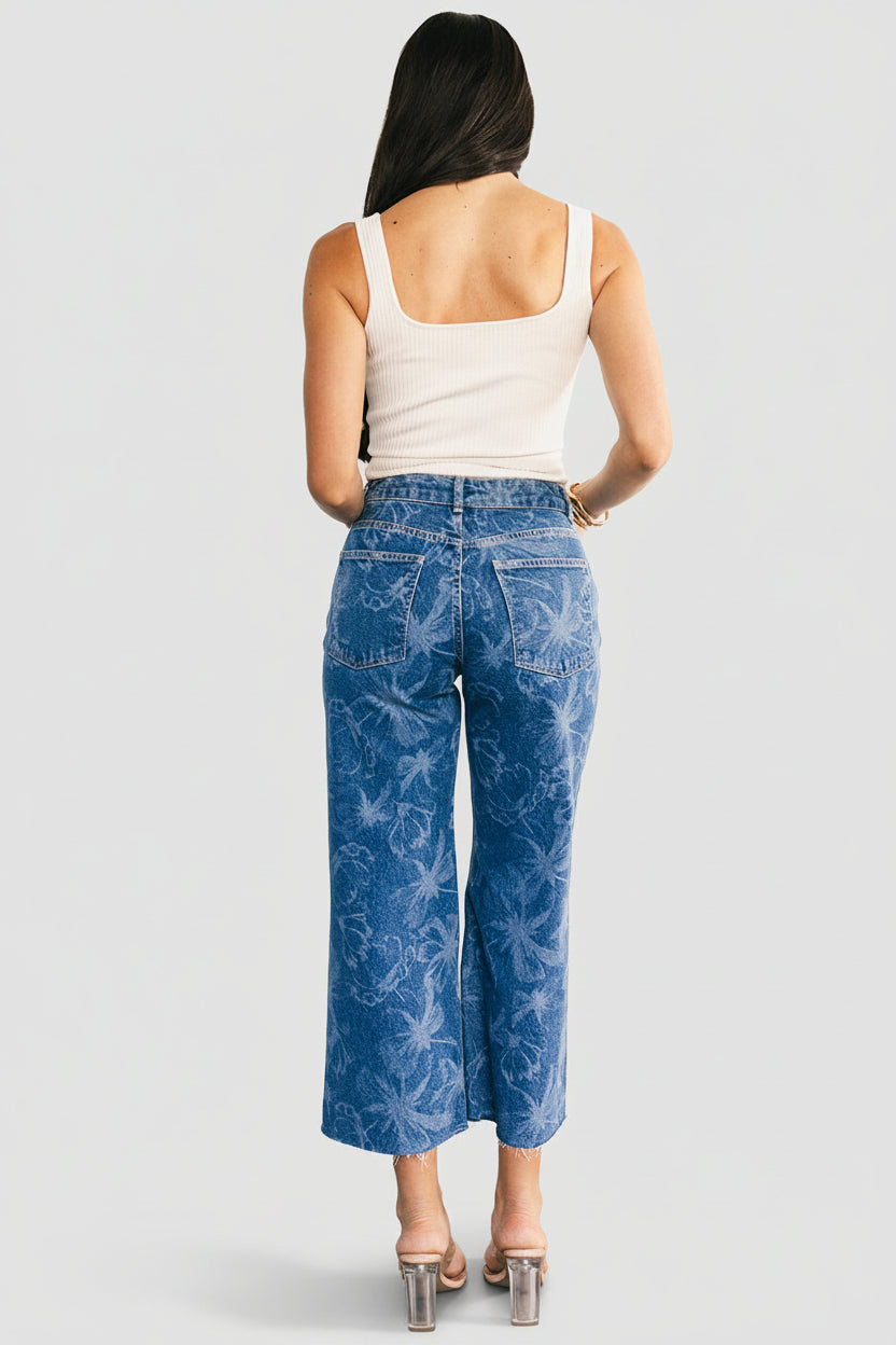 Waistband and closure detail showing button and zipper closure, belt loops, and laser-printed floral pattern on denim (approx. 103 chars)