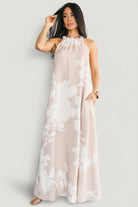 Front view of the Aurelia Halter Column Maxi Dress in natural with white print, showing halter neckline and column silhouette.
