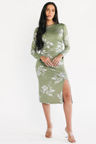 Front view of Valeria Midi Dress in sage with silver metallic floral pattern on model, showing boat neckline and fitted waist.