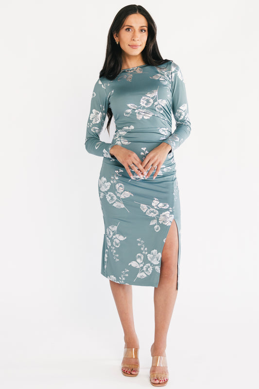 Front view of Valeria Midi Dress in vintage teal with silver metallic floral print, boat neckline, gathered left-side detail and left leg slit.