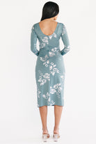 Side profile of Valeria Midi Dress in vintage teal, showing gathered left-side drape, elastic front waist and left leg slit movement.