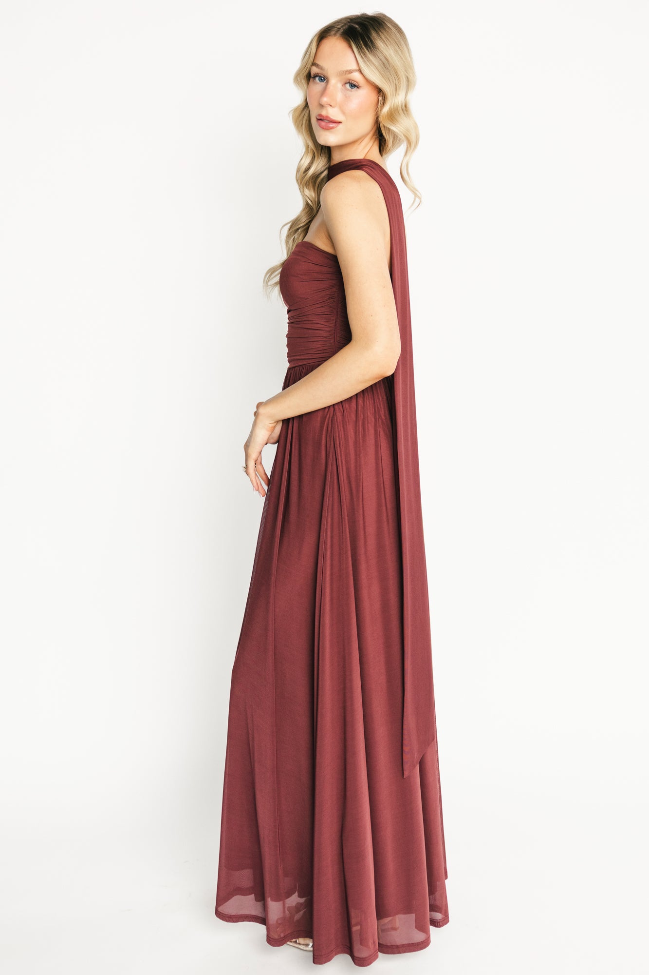 Back view of mahogany Elias maxi dress highlighting smooth back, secure strapless fit, and floor-skimming length.