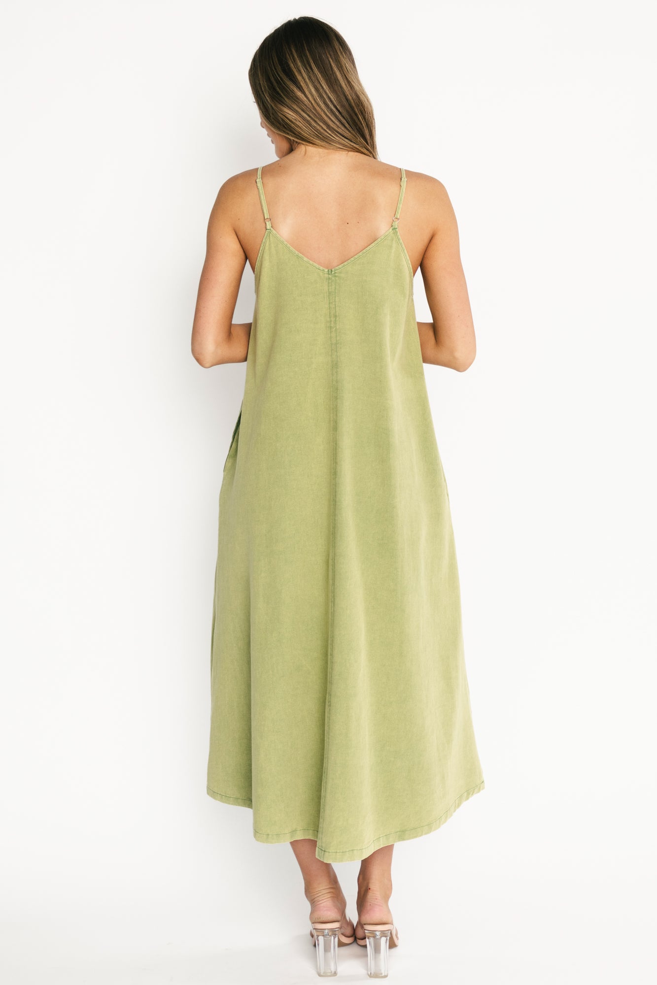 Back view of Marcia Maxi Dress displaying V-back, adjustable straps, and full maxi length in green wash lightweight cotton.