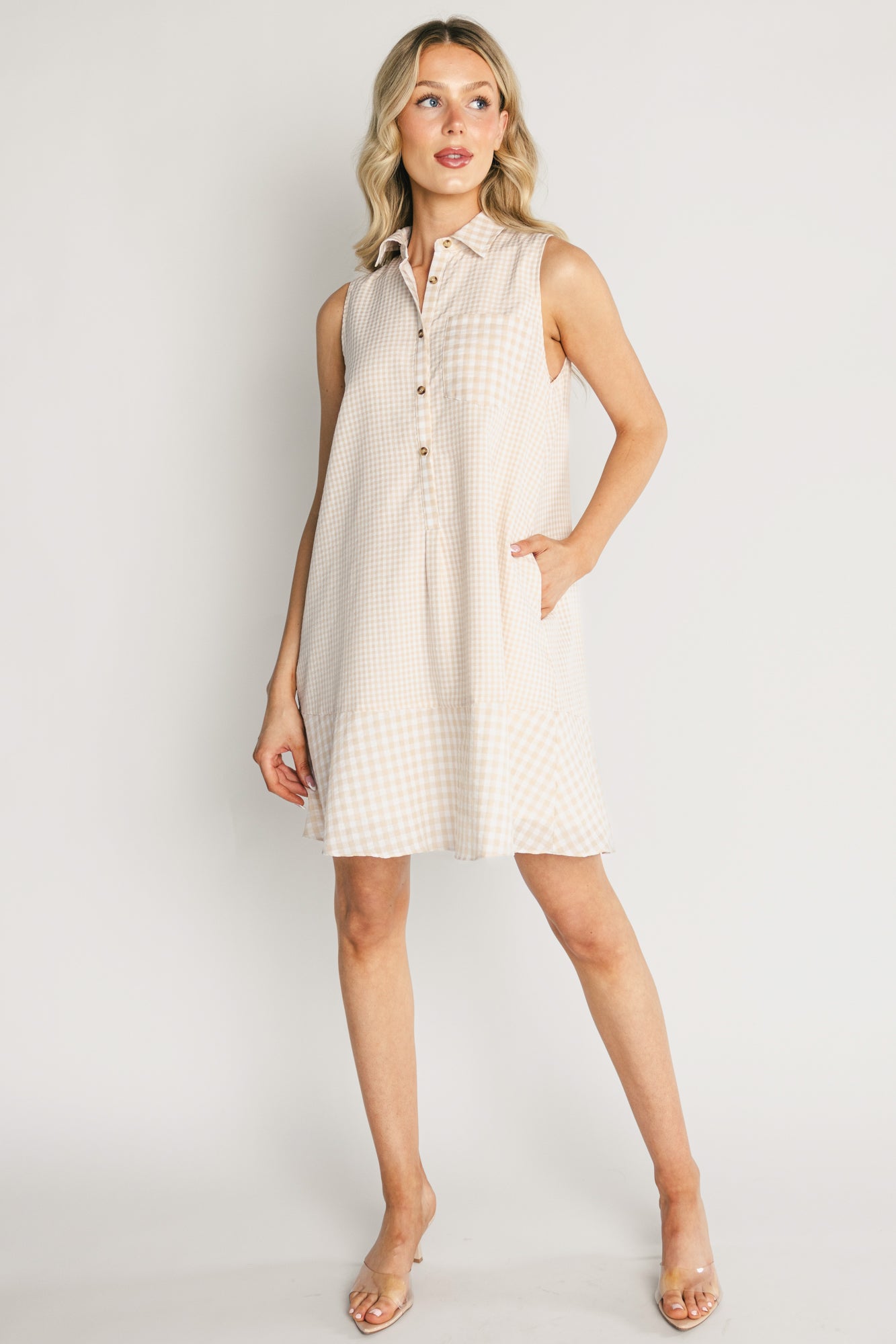 Front view of the Dolly Short Dress in beige and ivory gingham on a model, showing collared neckline, three-button front, left chest pocket, and swing hem.
