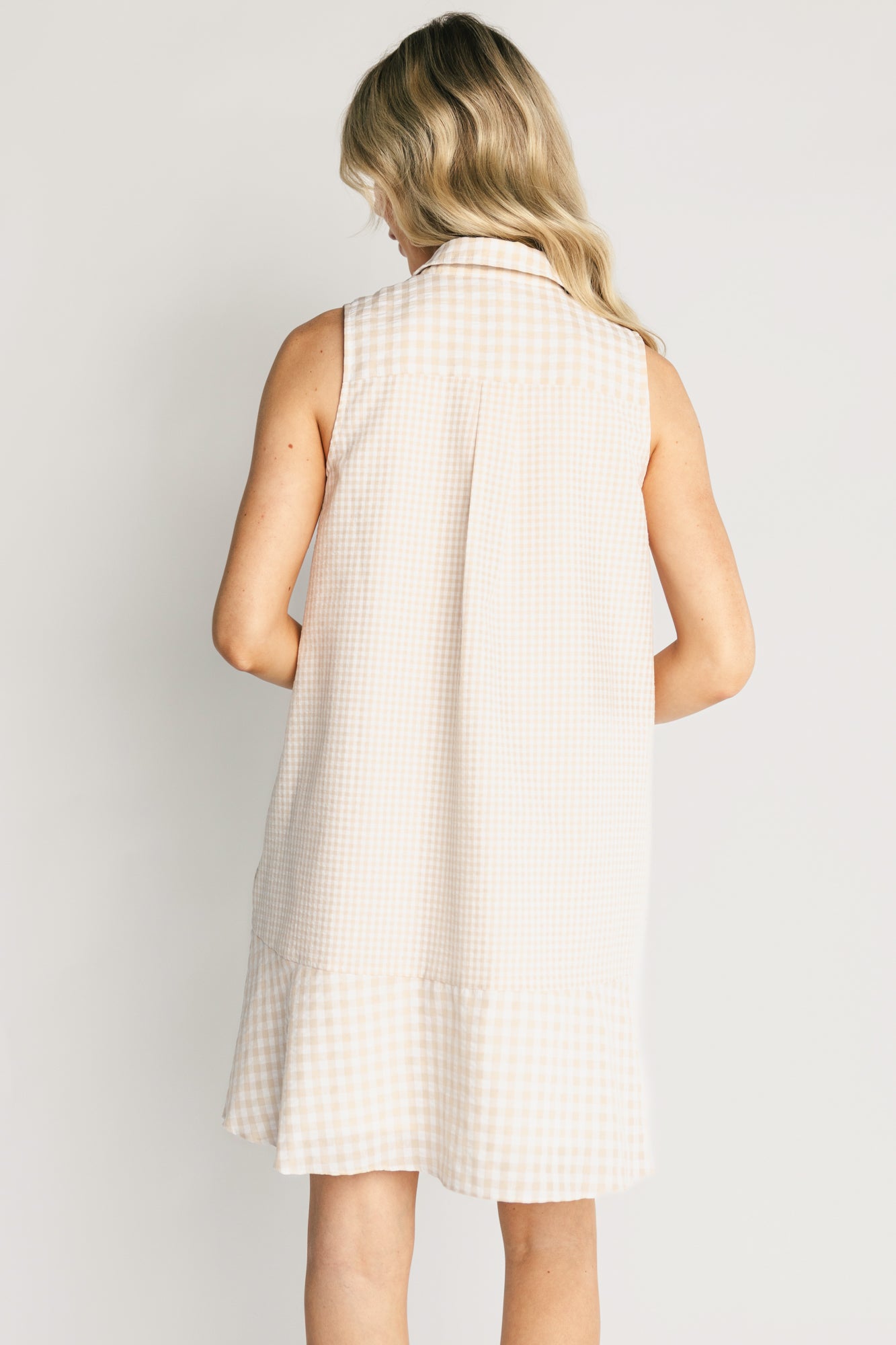 Model styling shot of the Dolly Short Dress paired with casual shoes, illustrating movement of the lined skirt, nursing-friendly button front, and comfortable silhouette.